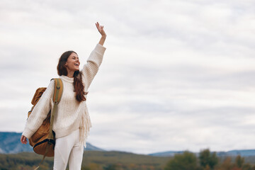 Poster - Mountain Adventure: Smiling Woman Enjoying Outdoor Cliff Hiking in Springtime