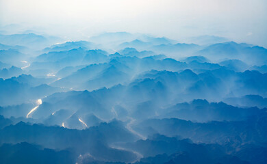 Wall Mural - aerial view of mountain range in fog