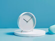 A white clock on a blue table.