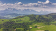 Aerial drone view over green hills of Pieniny National Park and snowy Tatra Mountains