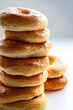 A stack of freshly baked bagels with a golden crust and soft interior