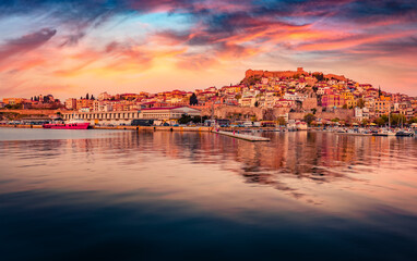 Wall Mural - Calm summer seascape on Aegean Sea. Exciting evening cityscape of Kavala port, the principal seaport of eastern Macedonia. Great sunset in Greece, Europe. Travel the world..