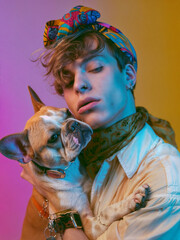 Wall Mural - Young stylish model with dog posing for edgy and modern fashion editorial. Conceptual photo on vivid background. Haute couture contemporary trends