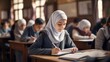 © ORG - Muslim girl in hijab making notes in copybook while sitting