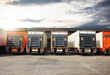 Trucks on The Parking Lot at Warehouse with The Sunset Sky. Cargo Container Shipping. Trucking. Lorry Diesel Truck. Freight Truck Logistics, Cargo Transport.	
