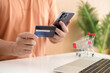 © littlepigpower - Online payment,Man's hands holding a credit card and using smart phone for online shopping