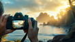 A photographer with a digital camera captures a breathtaking summer landscape of beach, ocean, and sunset sky. For magazines, photography, documentaries, travel, nature conservation, posters, backdrop