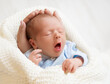 Newborn Baby Sleeping in Mother Hands, New Born Boy with open mouth yawning, one month Child wrapped in White Blanket. Infant Closeup