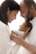 Family with Newborn Baby. Happy Parents holding one month Child. Smiling Mother and Father Silhouette with Infant over White. Parenting Love and Childcare