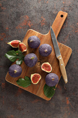 Sticker - Fresh ripe figs with a knife on a wooden board