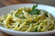 Zucchini noodles seasoned with herbs and spices in a white dish, garnished with parsley