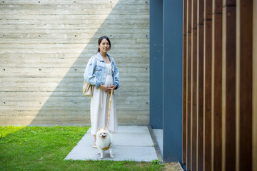 Poster - Asian Pregnant woman with her white pomeranian dog