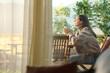 © Antonioguillem - Woman sitting in a terrace relaxing and drinking coffee