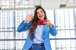 Business woman waving hand using smartphone app enjoying online virtual chat video call with friends in distance mobile chat virtual meeting, recording stories for social media at office building.