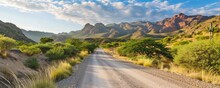 Background: Gravel Dirt Road Leading To A Mountain Or Hill