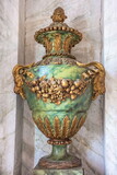 Fototapeta Las - An ancient stone vase decorated with stucco in the form of a garland of fruits
