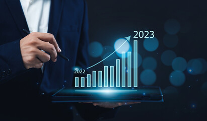 Poster - Businessman using a tablet to analyze company's financial revenue and profit with value increasing charts calculation, information computer system technology, using data to calculate business strategy