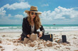 Businesswoman in suit creating sandcastles on sunny beach