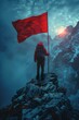 Man on peak with red flag in snowy mountains at sunset