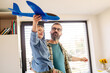Playing with lightweight styrofoam planes. Playful father and son throwing and flying foam glider planes. Fathers day and parental love concept.