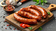 Board of tasty boiled sausages on grey background