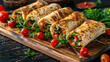 Board of tasty lavash rolls with vegetables and greens