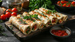 Board of tasty lavash rolls with vegetables and greens