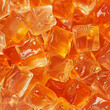 Fondo con detalle y textura de multitud de cubitos de hielo de color naranja con gotas de frescor