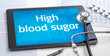 A tablet with the word High blood sugar on the display