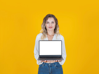 
Hold laptop mock up, young employee business woman or student caucasian blonde curly hair hold laptop mock up. Isolated yellow studio background. Blank empty white screen notebook computer promo.
