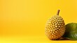 A ripe durian fruit rests on a vibrant yellow background, exuding a tropical charm