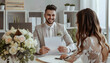 Male wedding planner working with couple in office
