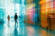 abstract light trails and dynamic motion blur of people walking in modern glass office building interior