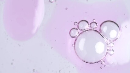 Wall Mural - Motion of molecule bubbles in a cosmetic serum, macro. Pink transparent cosmetic gel fluid with molecule bubbles.