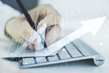 Poster - Multi exposure of abstract financial diagram with upward arrow and hand writing in notepad on background with laptop, rise and breakthrough concept
