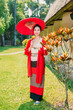 Northern Thai Chiangmai lanna people in traditional style clothes beautiful women old vintage dressing with paper umbrella at wat ton kwen.