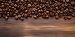 Freshly roasted coffee beans elegantly strewn across a polished wooden surface, emphasizing their glossy textures and rich brown hues—ideal for any culinary or lifestyle feature.