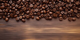 Fototapeta Do pokoju - Freshly roasted coffee beans elegantly strewn across a polished wooden surface, emphasizing their glossy textures and rich brown hues—ideal for any culinary or lifestyle feature.