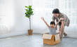 Asian single dad family father daughter girl packing cardboard box moving, online marketing e-commerce unpacking stuff belongings home delivery. Lifestyle happy white family together relocation