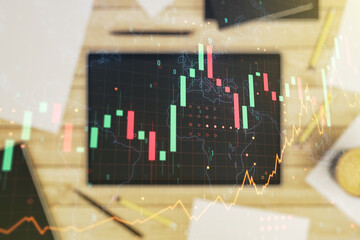 Poster - Multi exposure of abstract financial graph with world map and modern digital tablet on desktop on background, top view, financial and trading concept