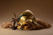 Golden Venetian carnival masks on a beige background.