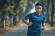 © darshika - Asian and Indian men jogging outdoors in sportswear.