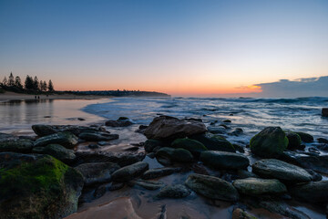 Wall Mural - Rocky beach coastline view during sunrise time, Sydney, Australia.