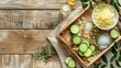 A wooden tray showcasing bowls of lemons, cucumbers, salt, and essential oils, perfect for adding flavor and freshness to dishes. A display of colorful produce and ingredients for a delicious recipe