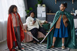 Full length portrait of two Black girls holding swords and acting out play in home theater