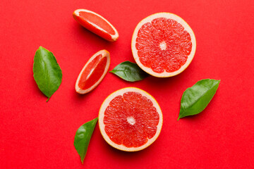 Wall Mural - fresh Fruit grapefruit with Juicy grapefruit slices on colored background. Top view. Copy Space. creative summer concept. Half of citrus in minimal flat lay with copy space
