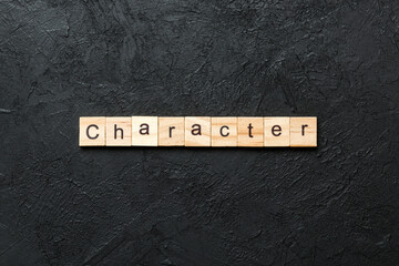 CHARACTER word written on wood block. CHARACTER text on cement table for your desing, concept