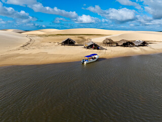 Wall Mural - Aerial view of Parque da Dunas - Ilha das Canarias, Brazil. Huts on the Delta do Parnaíba and Delta das Americas. Lush nature and sand dunes. Boats on the river bank
