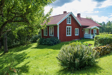 Poster - Idyllic red cottage by the forest edge