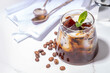 Coffee Jelly Dessert made with strong espresso coffee, gelatin or agar and whipped cream. Asian cold coffee sweets kohii zerii kanten on white table background copy space